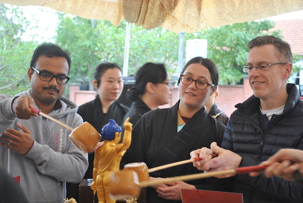 Bathing the little Buddha